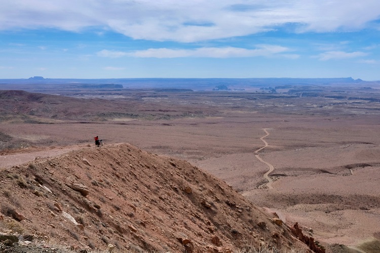 Cyclist biking on road on Utah’s Grand Staircase Loop